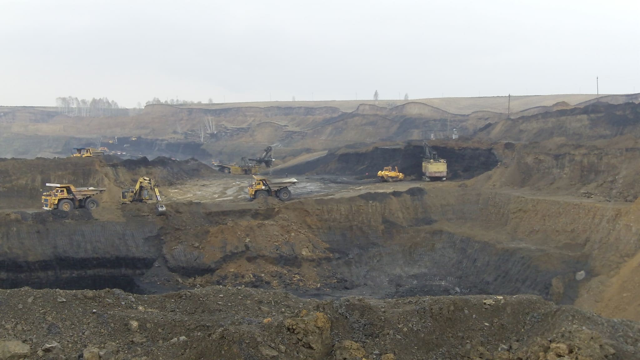 Large-scale mining operation using Dymax excavation buckets in a quarry environment