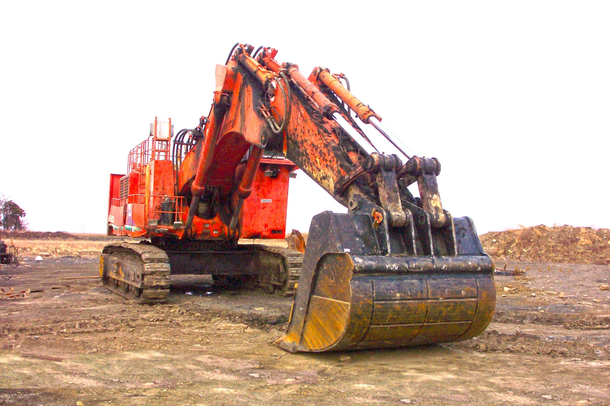 Dymax rock and mass excavation bucket mounted on a large hydraulic excavator in a mining application