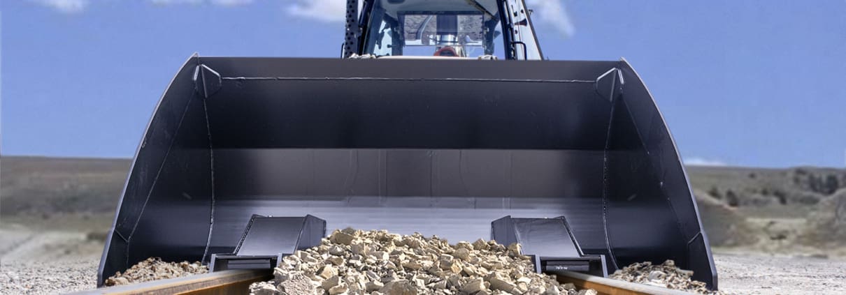 Dymax railway bucket cleaning up ballast on railway tracks