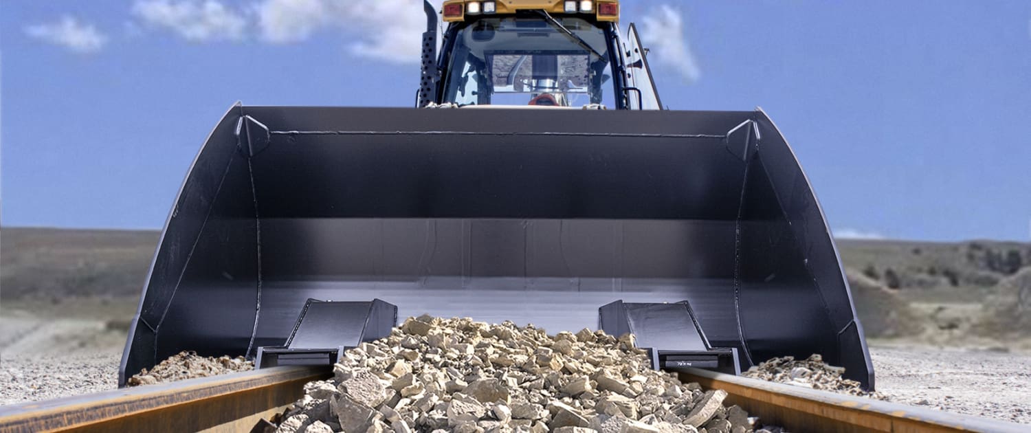 Dymax railway bucket cleaning up ballast on railway tracks
