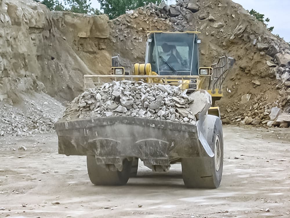 Wheel loader carrying blasted rock with a spade nose quarry rock bucket