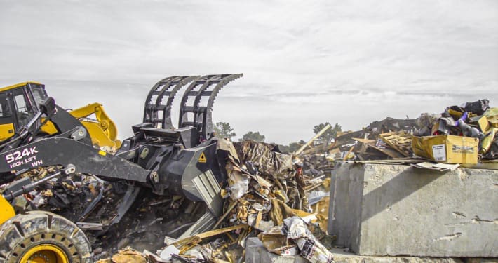 Dymax Grapple Bucket loading scrap materials in Missouri, on a Deere 524 high lift wheel loader.