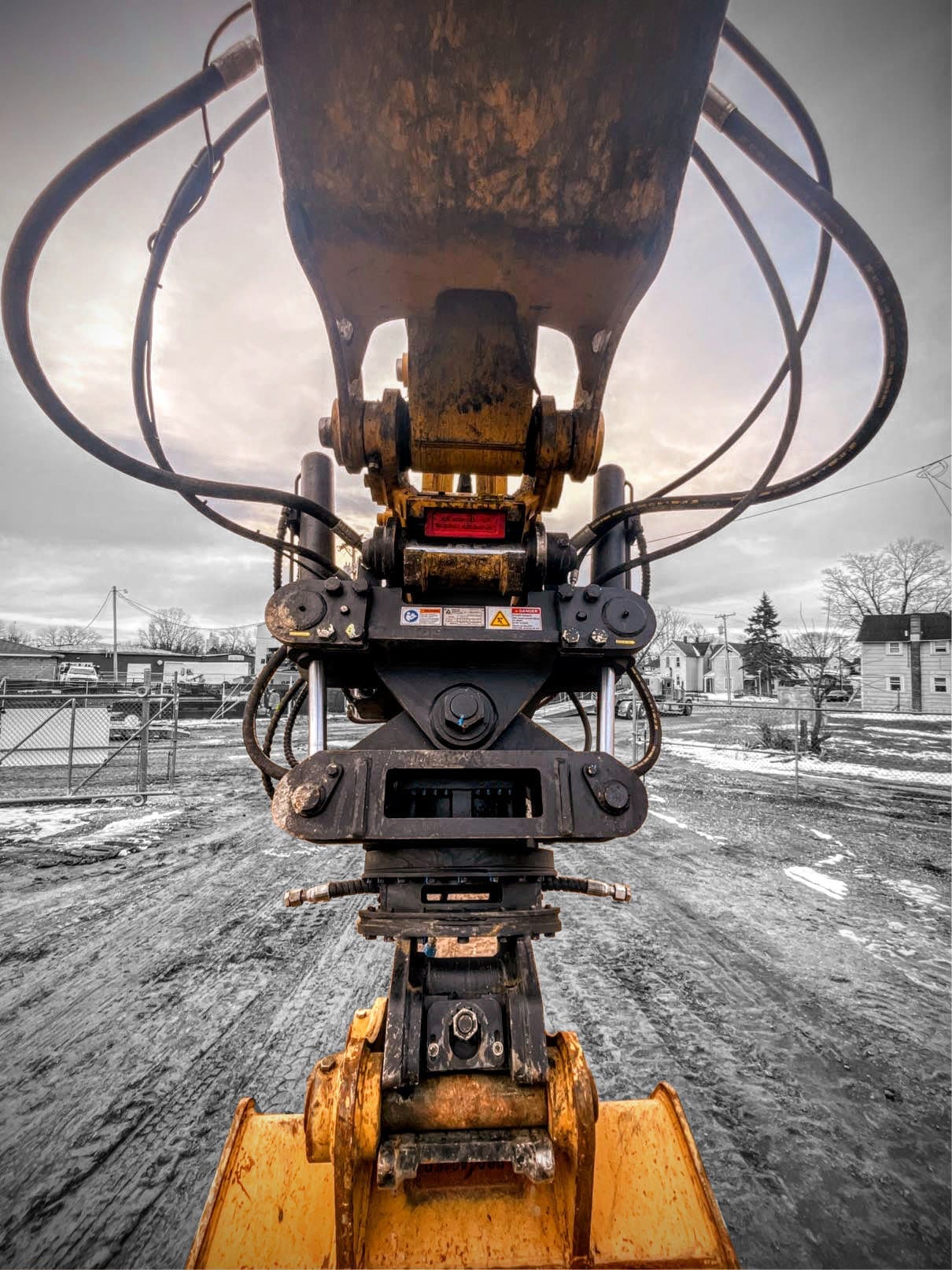 Dymax Tiltrotator Quick Coupler mounted on Caterpillar excavator in jobsite conditions