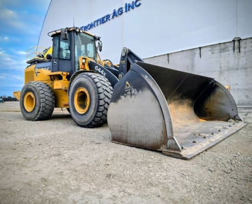 A John Deere 644K loader equipped with a Dymax extra-wide corn bucket at Frontier Ag, used for efficient bulk corn loading.